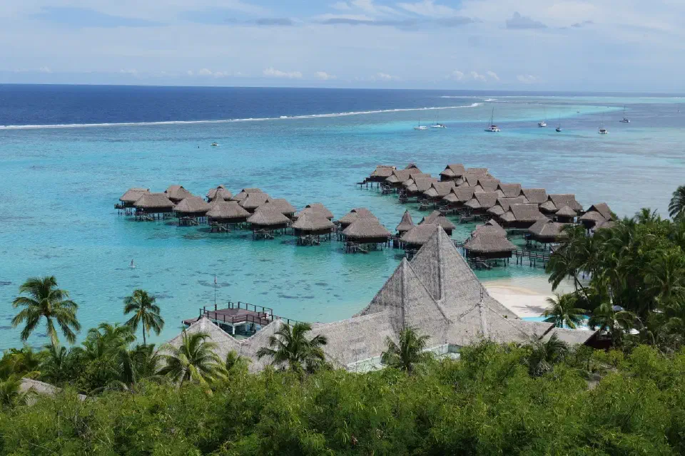 Türkis schimmernde Lagune und die berühmten Pfahlbungalows – ein Postkartenpanorama, das Moorea weltweit bekannt gemacht hat.