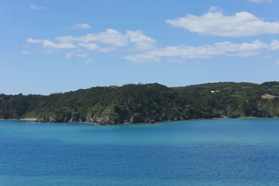 Blick über die türkisfarbenen Gewässer der Bay of Islands, deren ruhige Schönheit einen starken Kontrast zur historischen Bedeutung der Region bildet.
